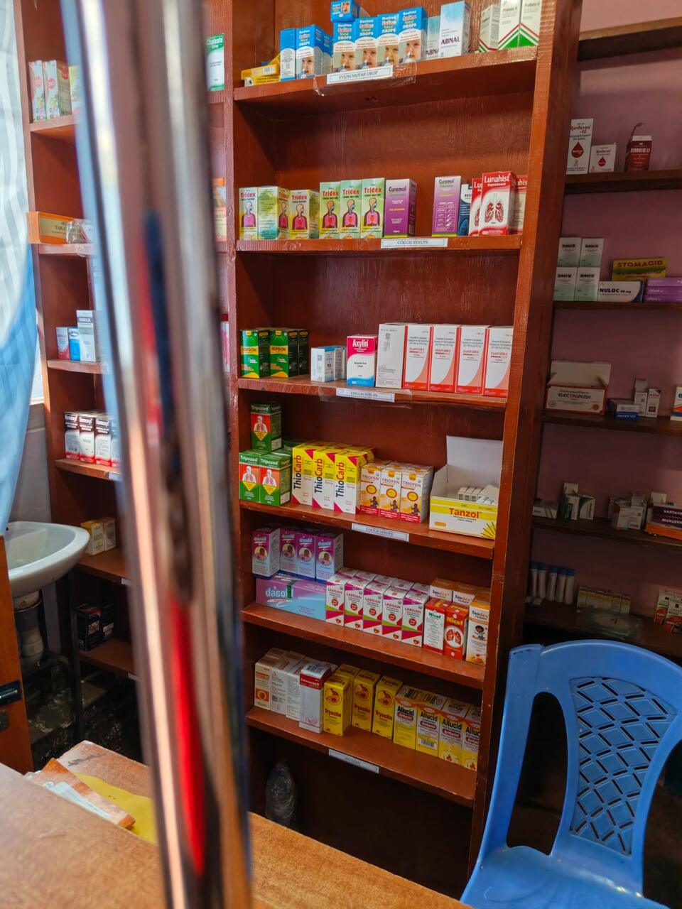 Shelves in the Primegala pharmacy, with cough syrups, children's medicines and antacids sorted by type