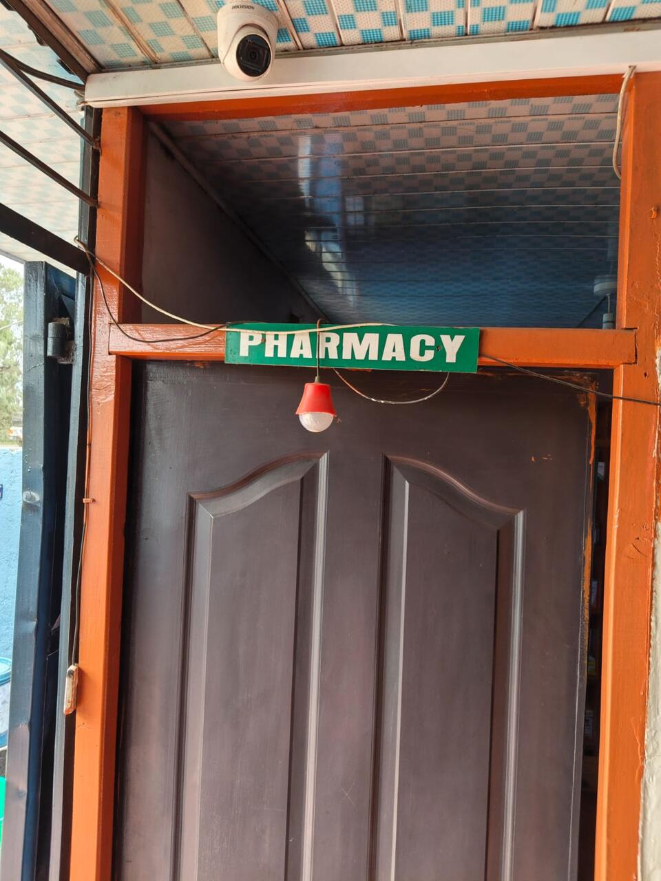The Primegala pharmacy door, marked with a green 'Pharmacy' sign